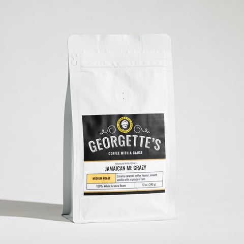 A white stand-up bag of Georgette's Coffee with a black and white label reading Jamaican Me Crazy on a light gray background.
