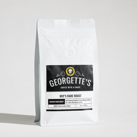 A white stand-up coffee bag with a black front label reading Georgette's Coffee, Roy's Rare Roast, photographed on a clean white studio background.