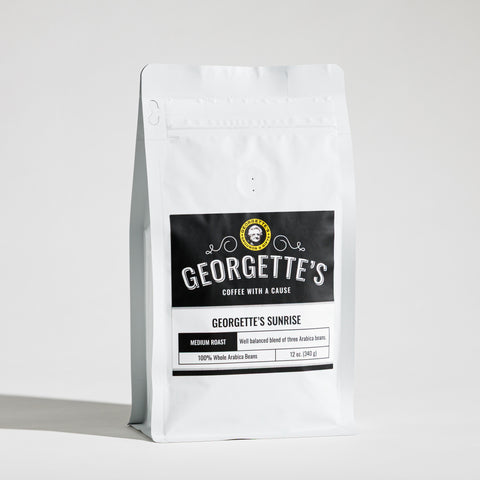 A white stand-up coffee bag with a black front label reading Georgette's Coffee, Georgette's Sunrise, photographed on a clean white background.