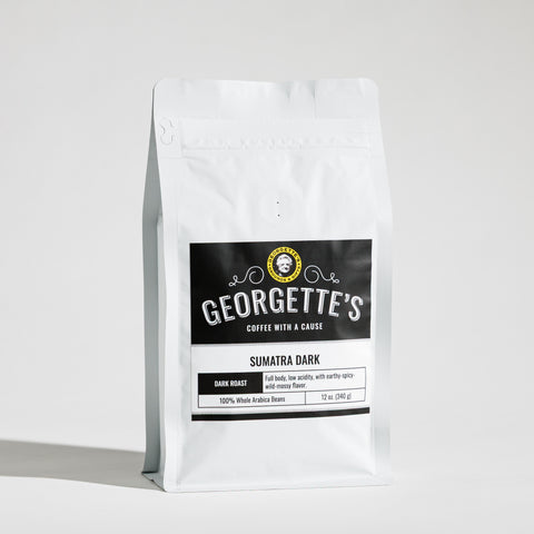 A white stand-up coffee bag with a black front label reading Georgette's Coffee, Sumatra Dark, photographed on a clean white studio background.