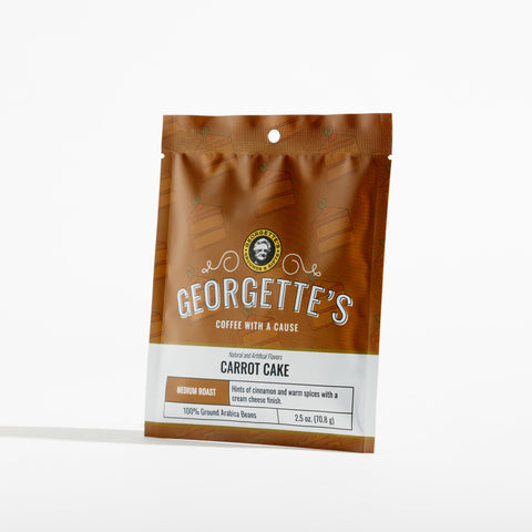 A bag of Georgette's Carrot Cake coffee, shown in a brown and white packaging on a light gray background.